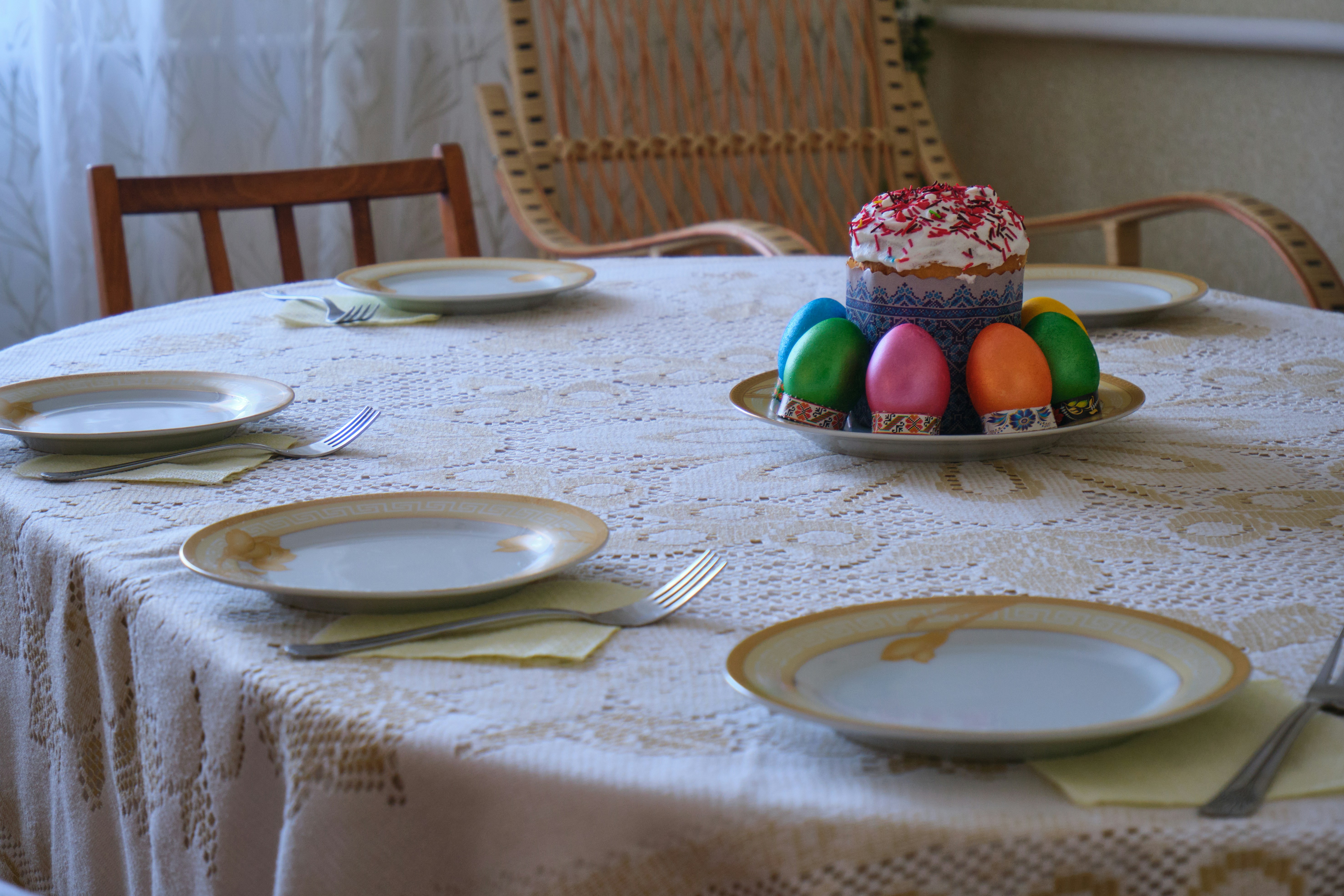 Italian Easter table set with place settings and colorful decorative eggs