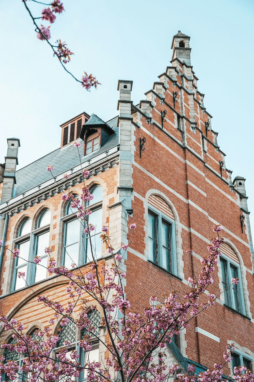 a tall brick building with a clock on the top of it