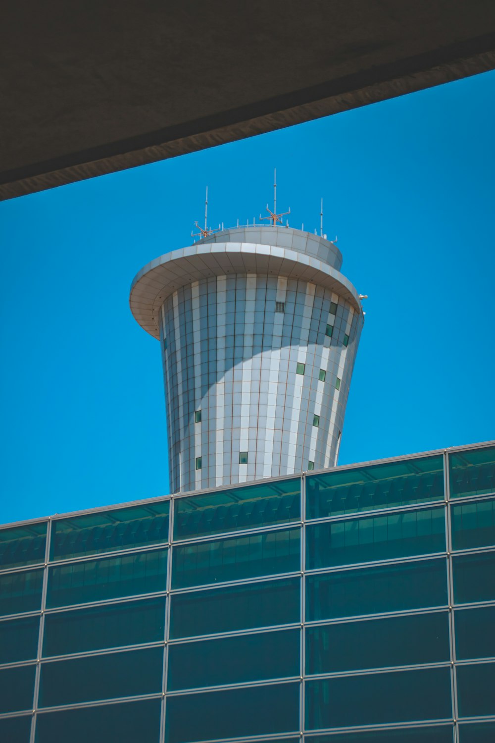 a tall building with a very tall tower next to it