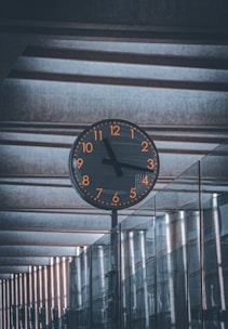 a clock on a pole in a building