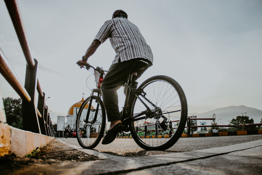 a man riding a bike down a street