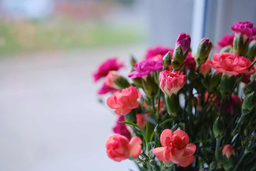 a vase filled with pink and purple flowers