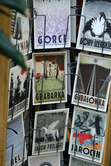 Colorful artistic postcards arranged on a rustic wooden table