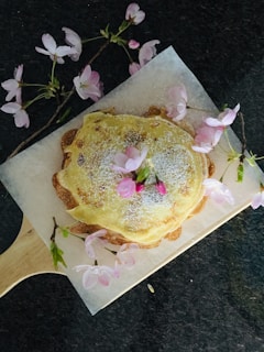 An 8-inch minimalist Japanese sponge cake elegantly presented on a rustic wooden board.