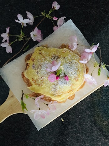 An 8-inch minimalist Japanese sponge cake elegantly presented on a rustic wooden board.