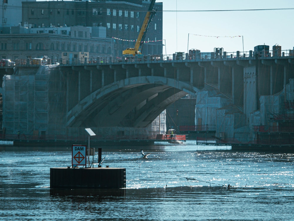 a bridge over a body of water next to a tall building