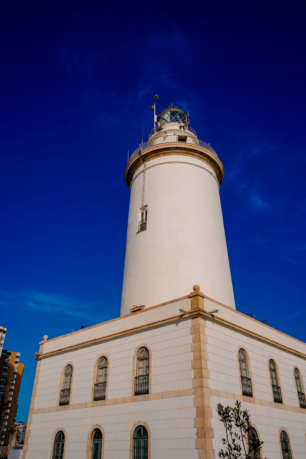 a tall white building with a clock on top