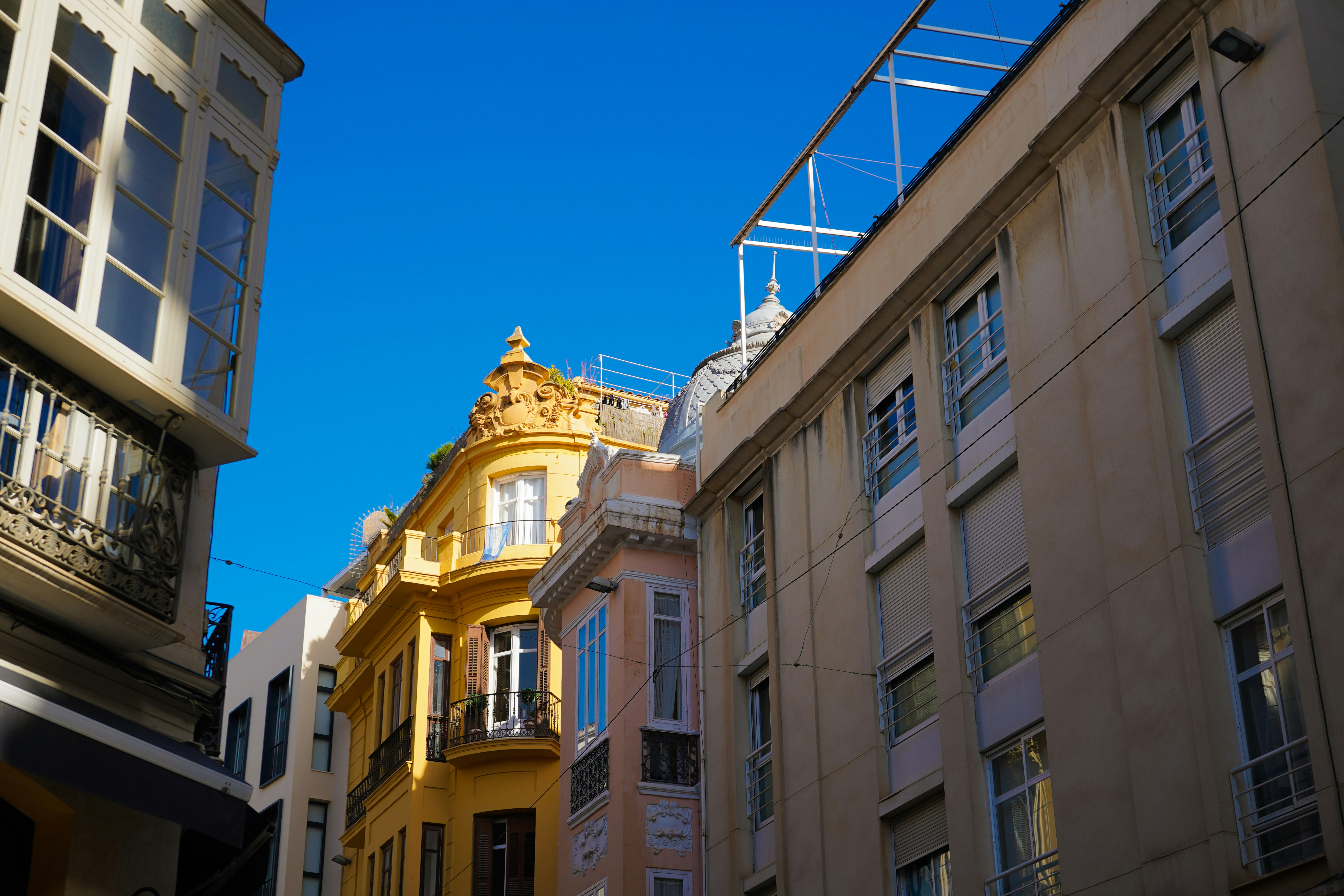 A row of buildings with a blue sky in the background