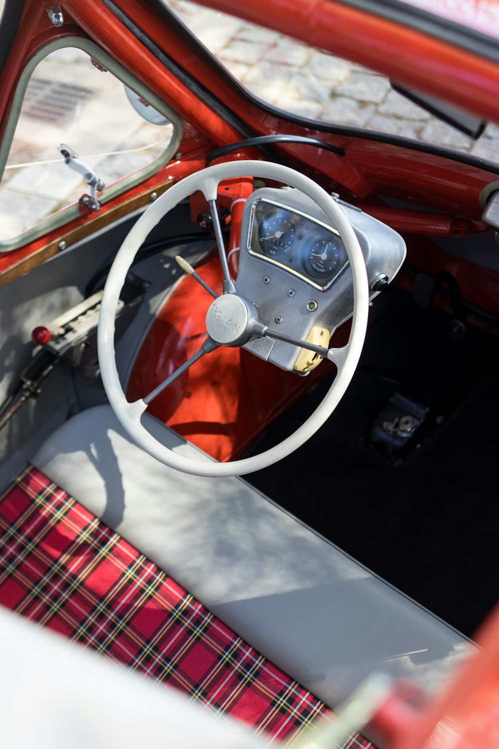 a red and white car with a steering wheel