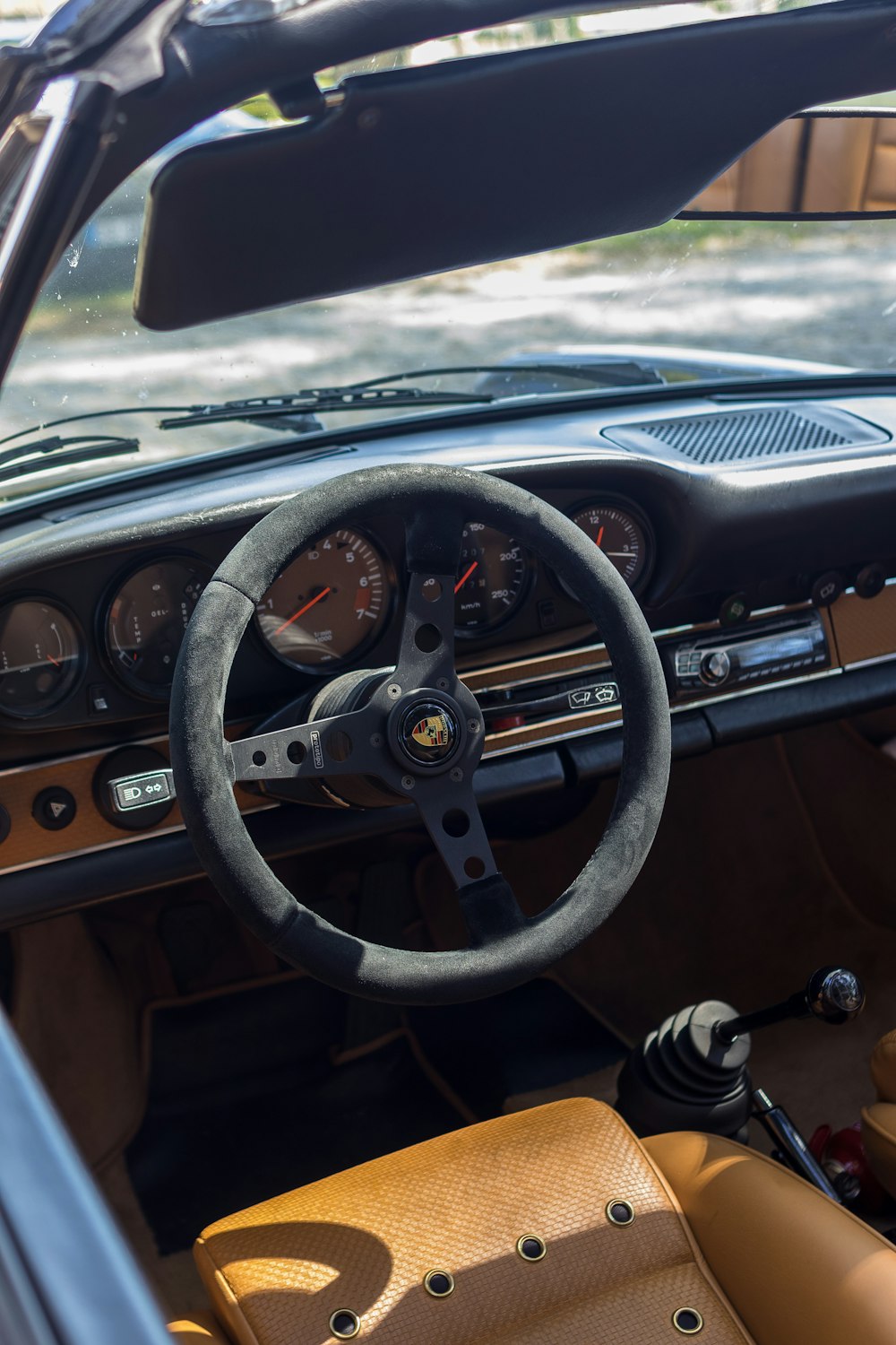 the interior of a car with a steering wheel and dashboard