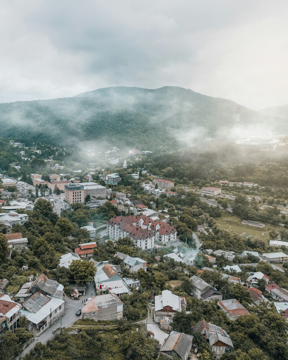 an aerial view of a town surrounded by mountains