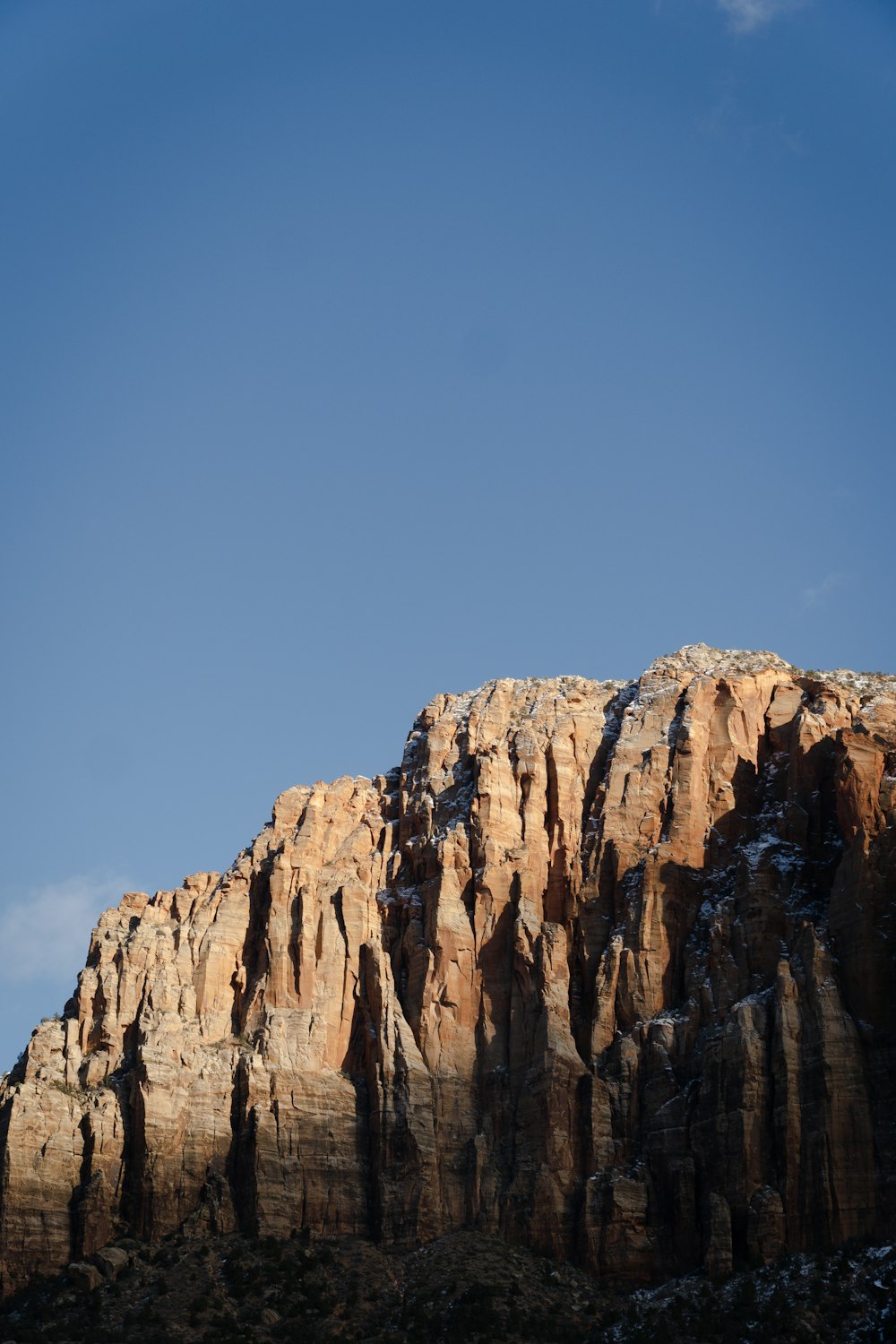 a very tall mountain with a sky in the background