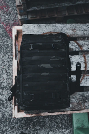 Close-up of a rugged tactical backpack with multiple compartments and MOLLE webbing.