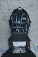 A rugged backpack filled with camera gear, packed for a day of shooting.