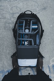 An open backpack with shoes packed inside a kelvinp llc waterproof shoe organizer bag.