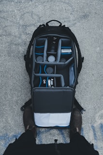 A rugged backpack filled with camera gear, packed for a day of shooting.