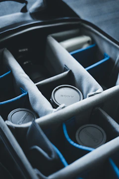 Photographer packing camera gear carefully into the spacious compartments of a perle path rolling bag