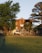 A happy customer standing in front of a beautiful house in Brusque, SC.