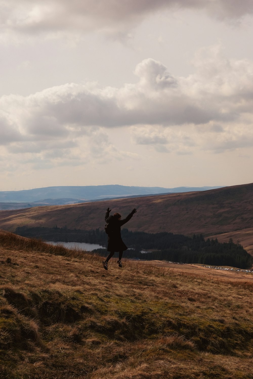 a person jumping in the air on a hill