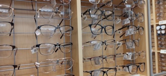 Close-up of stylish eyeglass frames displayed on a wooden table.