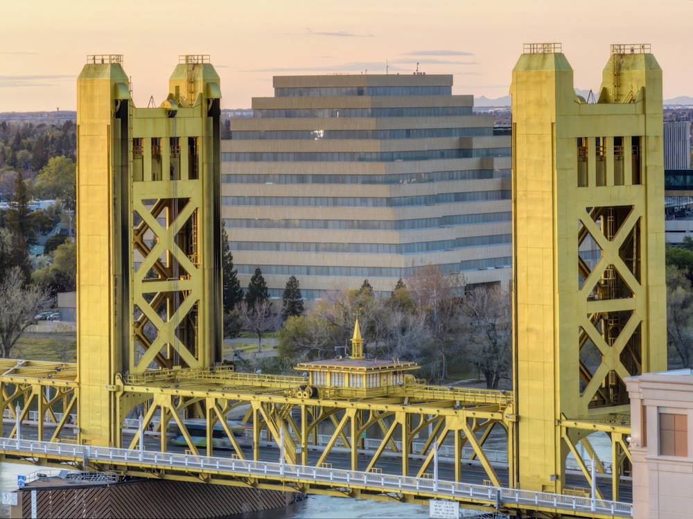 a yellow bridge with a building in the background