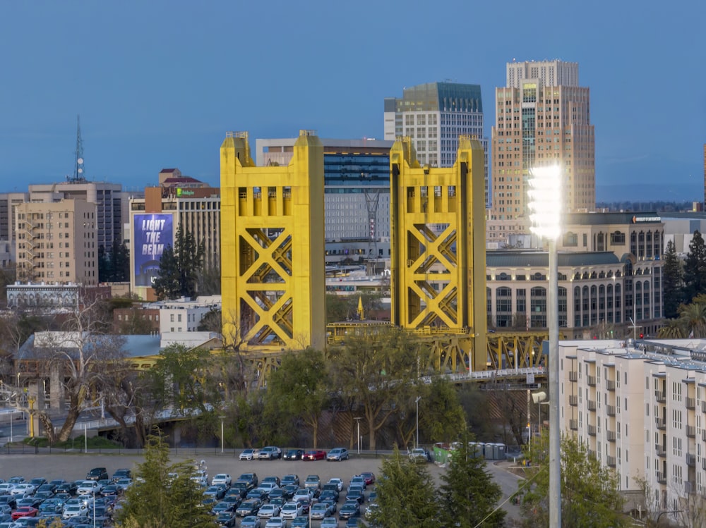 a large yellow bridge over a parking lot