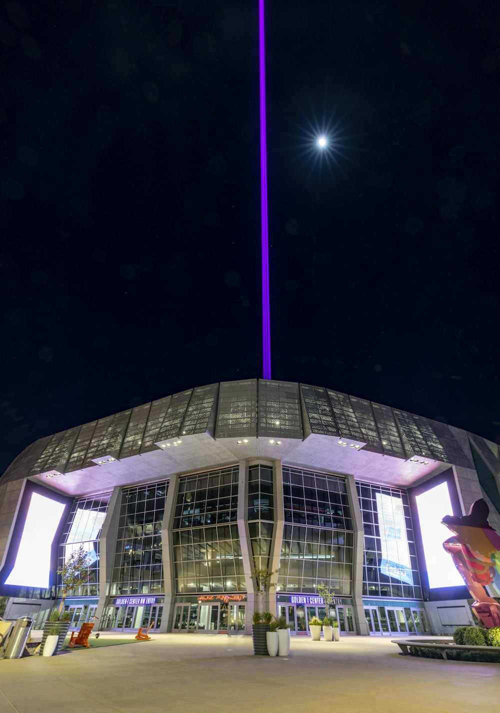 a large building with a purple light on top of it