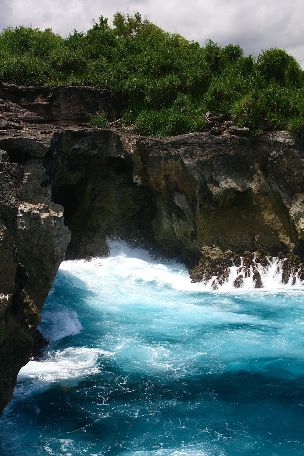 a large body of water next to a rocky cliff