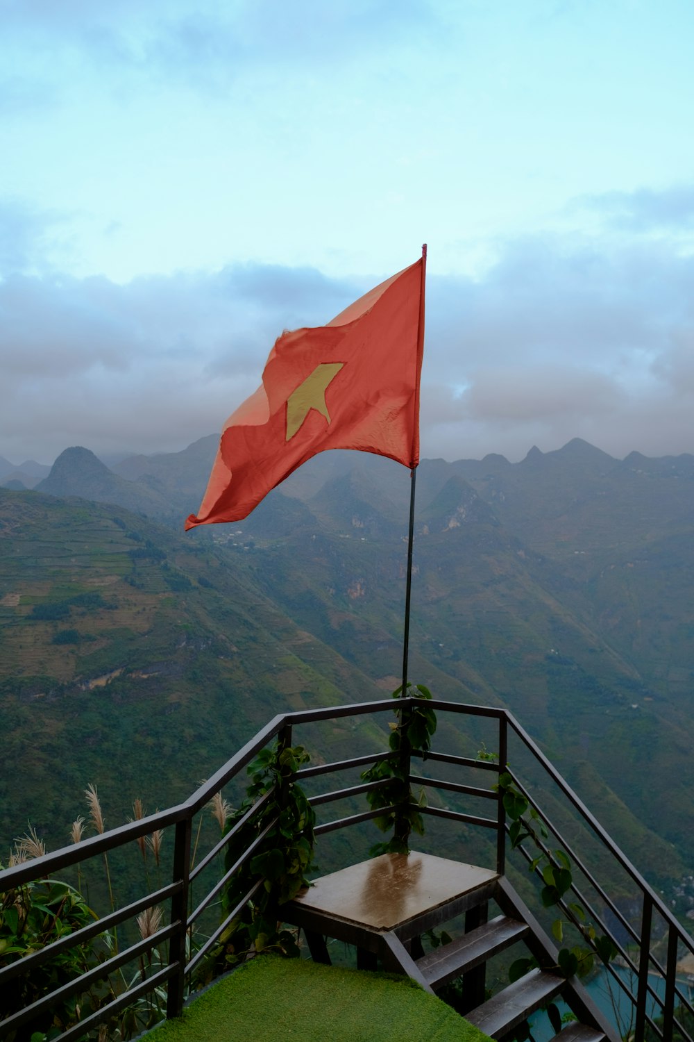 a flag flying on top of a metal railing