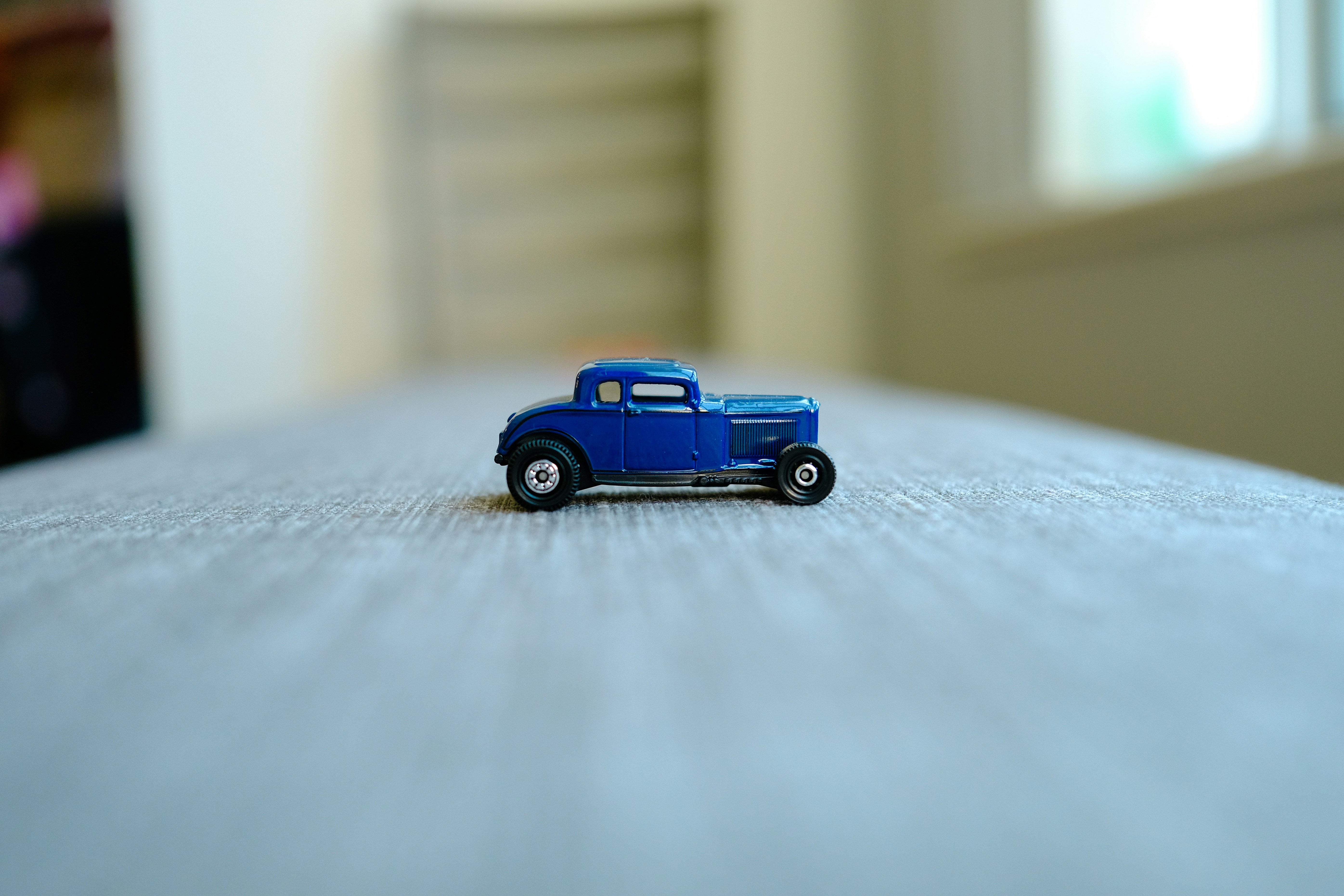 a toy truck sitting on top of a bed