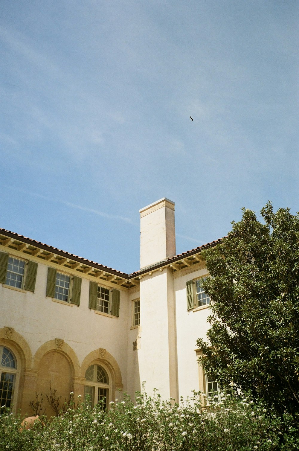 a large white house with a clock tower