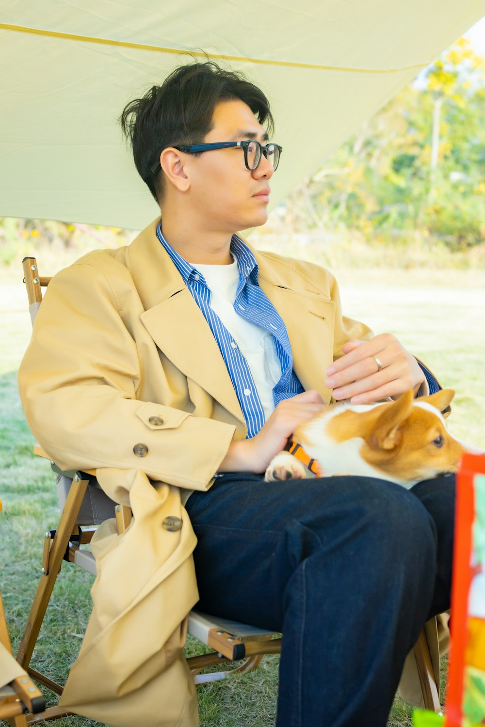 a man sitting in a chair holding a dog