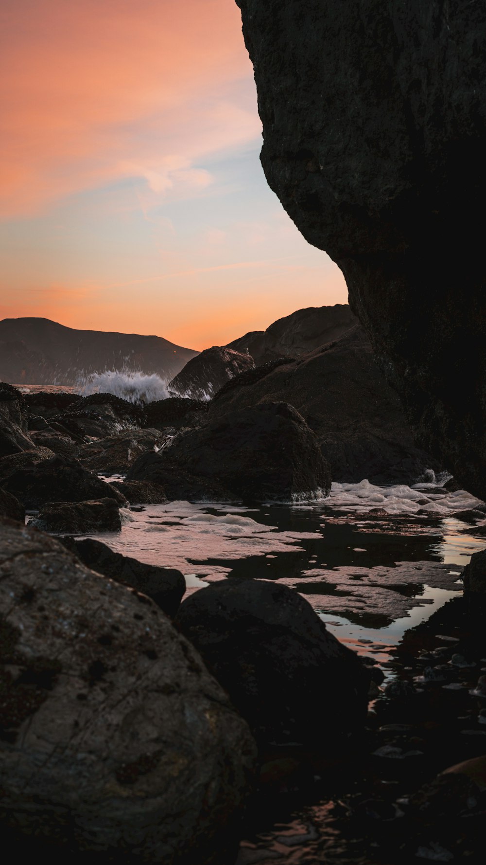 a view of the ocean from inside a cave