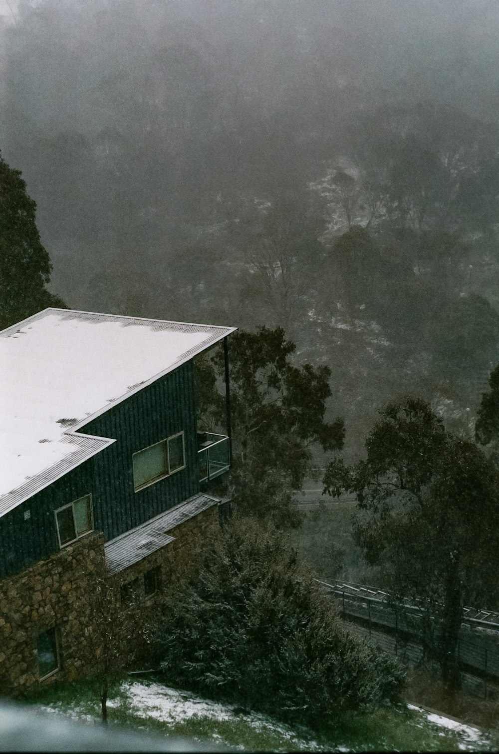 a house in the middle of a snowy forest