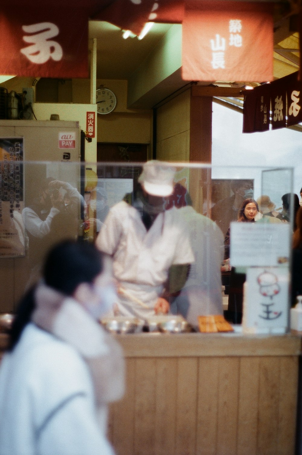a blurry photo of a man behind a counter