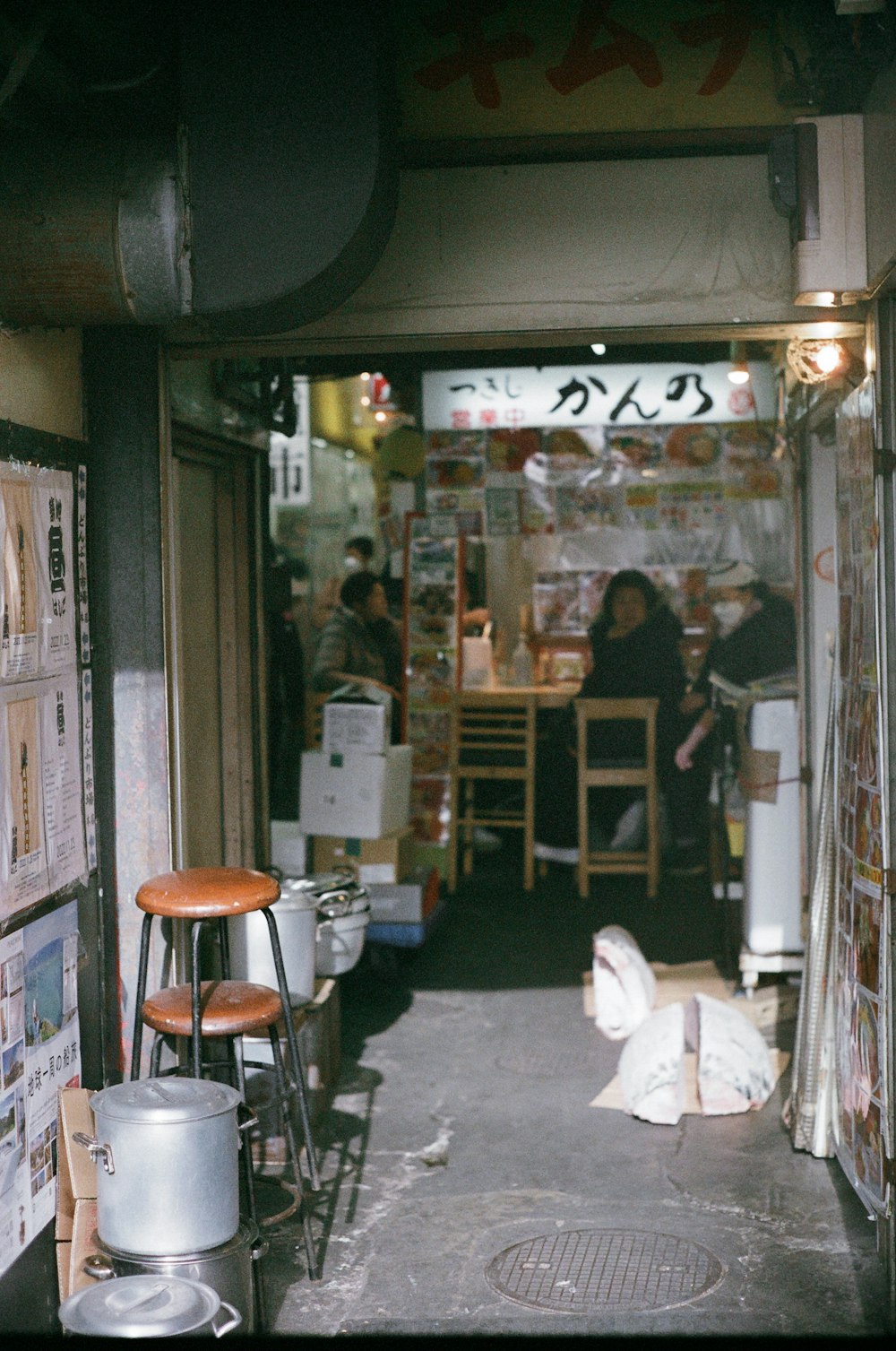 a narrow alley way with a bunch of signs on the wall