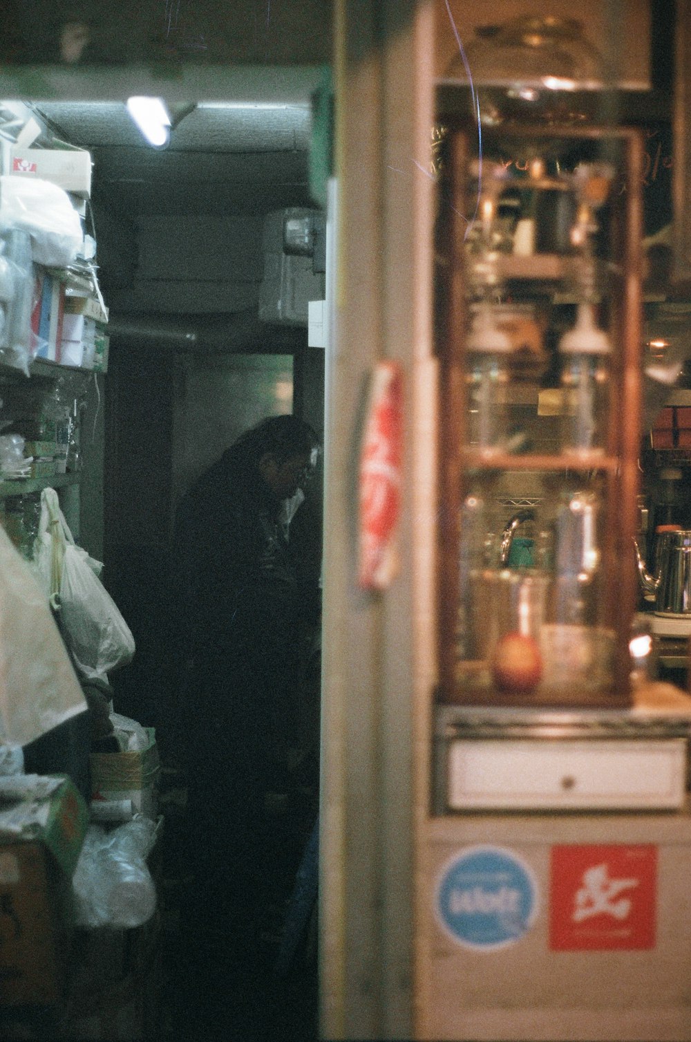 a man standing in a kitchen next to a refrigerator