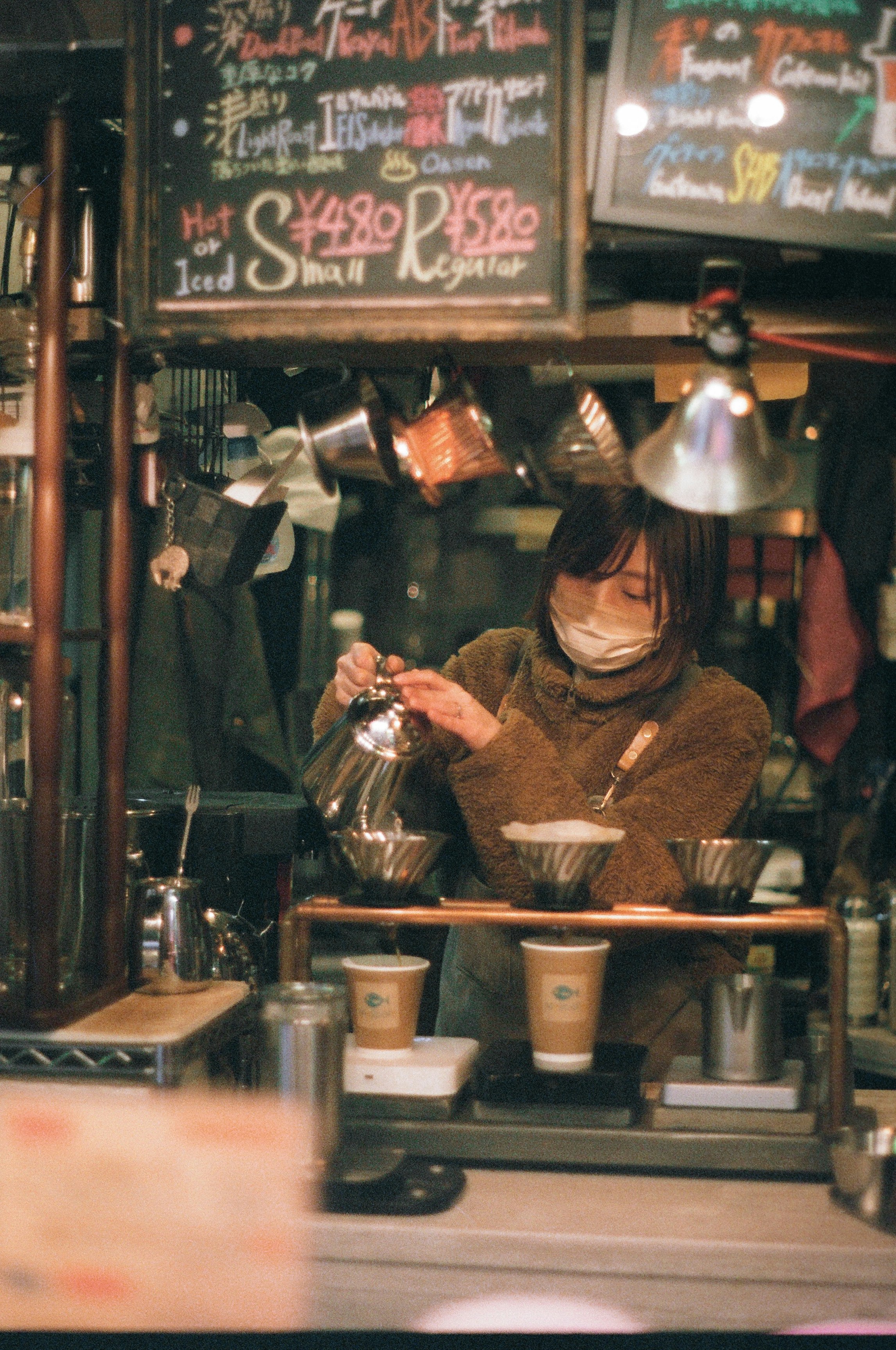a woman sitting at a counter in a restaurant