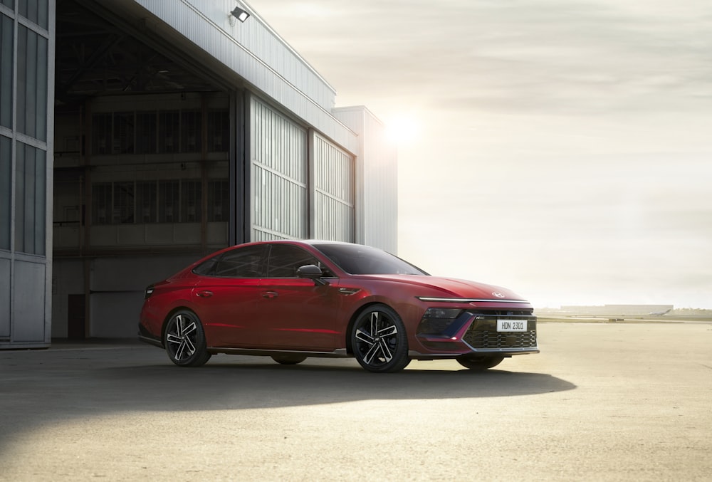 a red car parked in front of a building