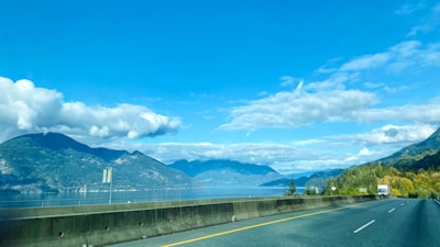 A scenic view of a truck on a highway.