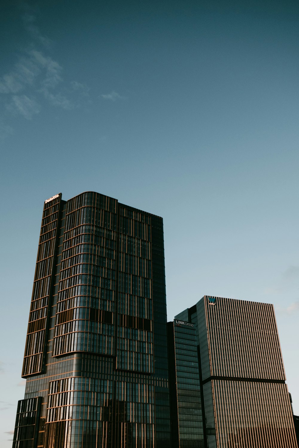 a couple of tall buildings sitting next to each other