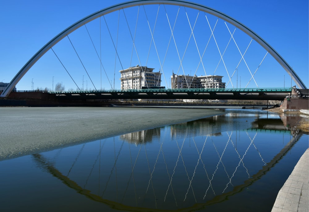 a bridge over a body of water with buildings in the background