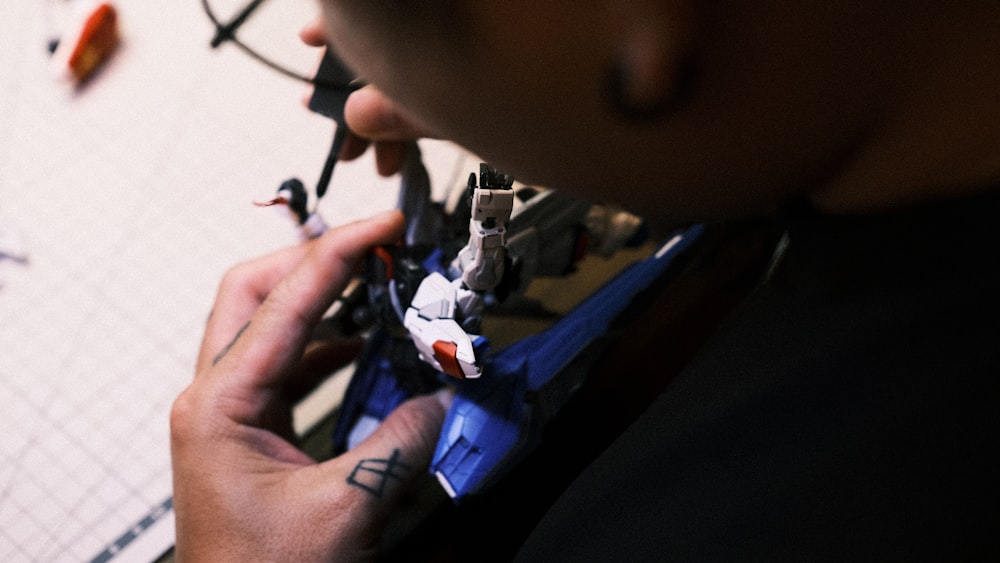 a close up of a person holding a pair of scissors