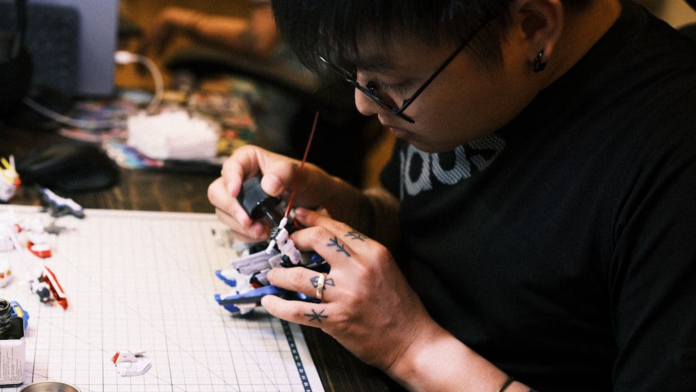 a man sitting at a table working on a project