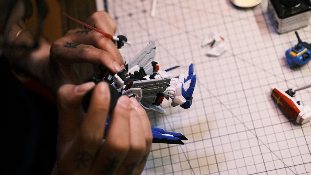 a person working on a toy airplane on a table