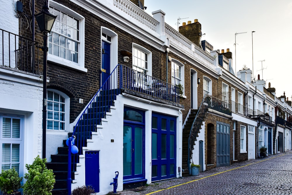 a row of brick buildings with blue doors