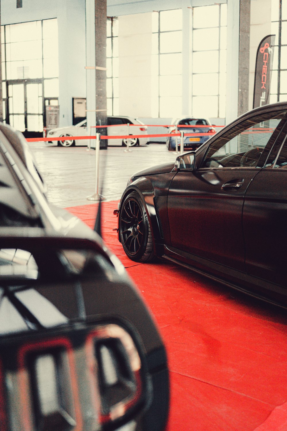 a car parked in a garage next to another car