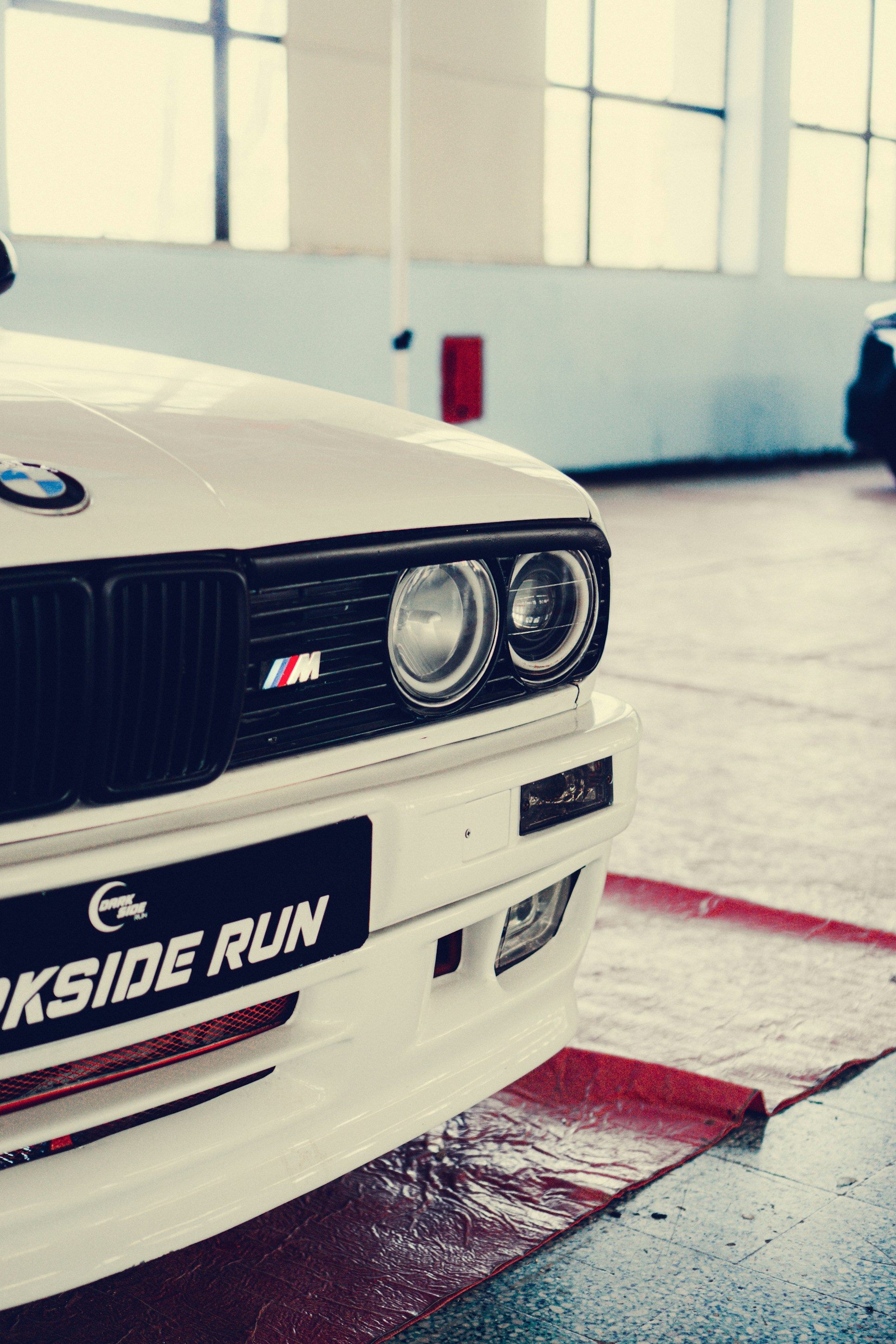 a white bmw car parked in a garage