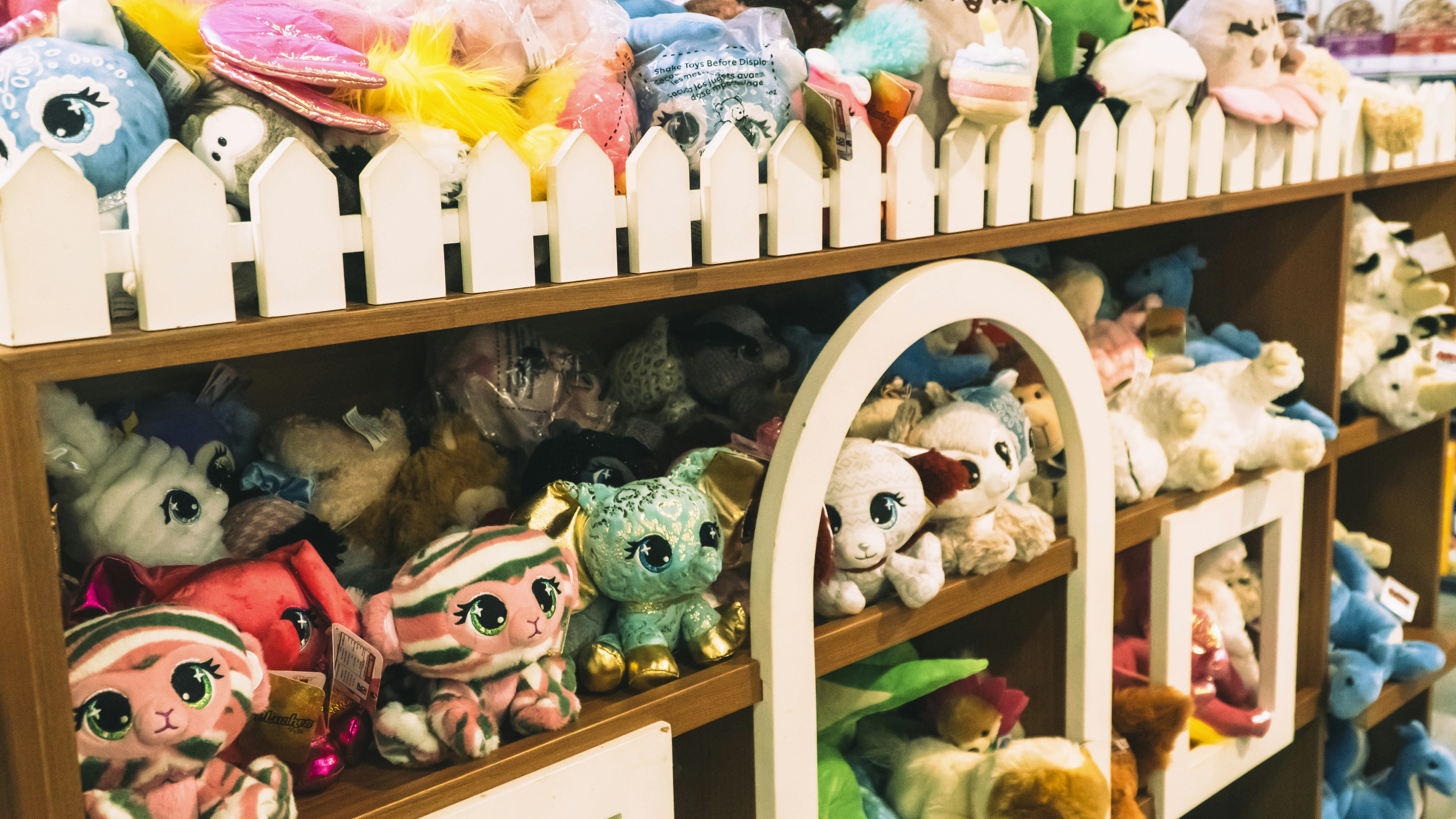 a shelf filled with lots of stuffed animals, 