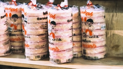 Brightly lit shelf showcasing a range of cannabis edibles with colorful packaging.